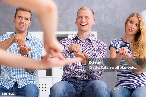 People Repeating Signs After Their Teacher Stock Photo - Download Image Now - Learning, Sign Language, Classroom