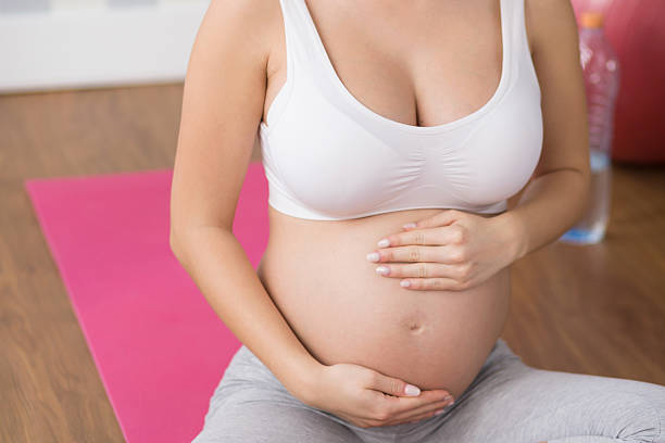 istock Pregnant woman doing breathing exercise 621572588