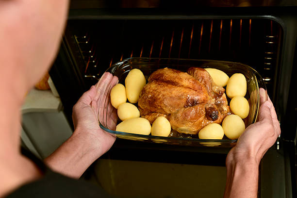 istock young man preparing a roast turkey 621572770