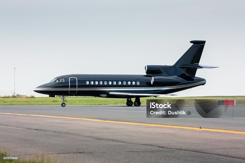 Black business jet taxiing from the runway Corporate Jet Stock Photo