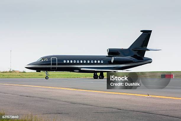 Black Business Jet Taxiing From The Runway Stock Photo - Download Image Now - Corporate Jet, Air Vehicle, Aircraft Wing