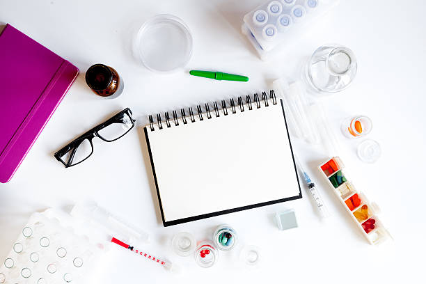 istock doctor workplace at lab top view on white background 621573726