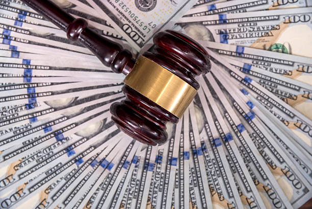 istock wooden hammer with dollar 621574822