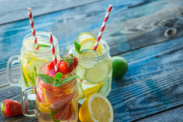 istock Jugs with lemon, lime, strawberry and cucumber infused water 621575238