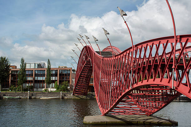istock Red steel pedestrian bridge in Amsterdam over the river 621575700