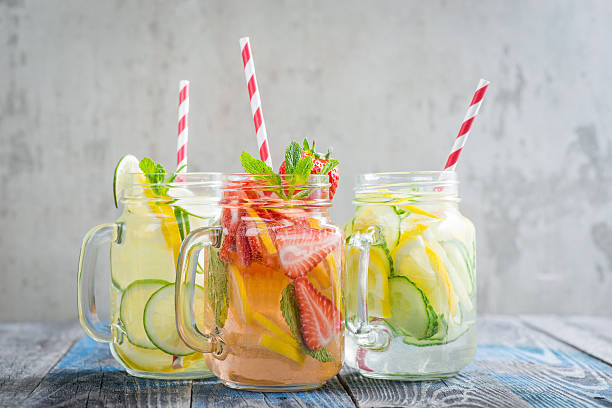 istock Jugs with lemon, lime, strawberry and cucumber infused water 621577430