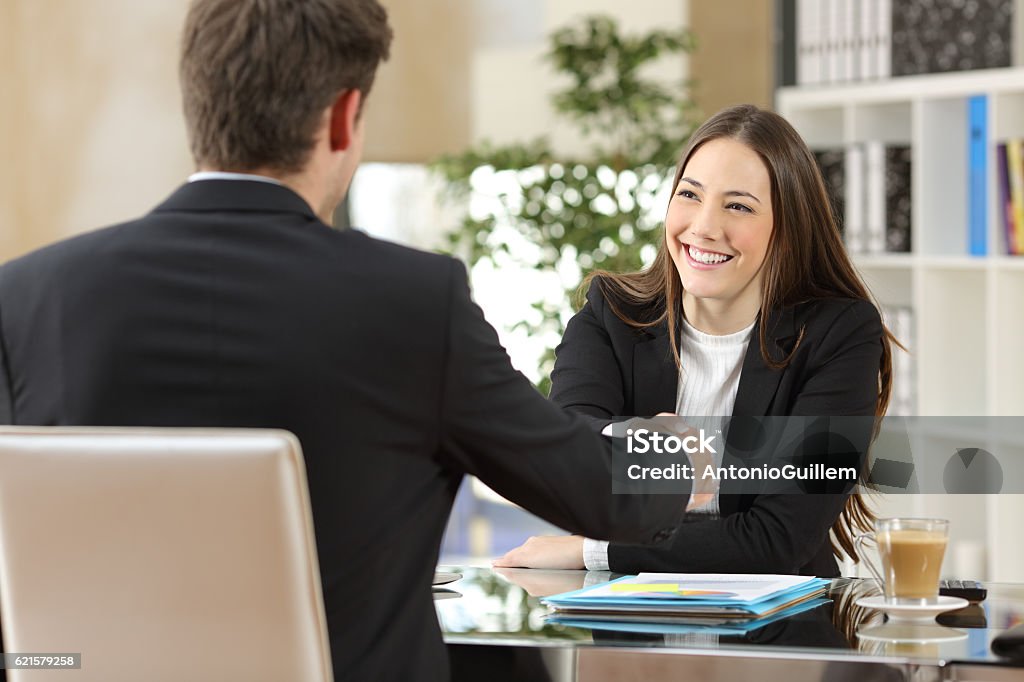 Businesspeople handshaking after negotiation Businesspeople handshaking after negotiation or interview at office Job Interview Stock Photo
