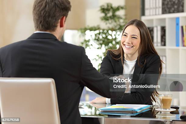 Businesspeople Handshaking After Negotiation Stock Photo - Download Image Now - Job Interview, Young Adult, Contract