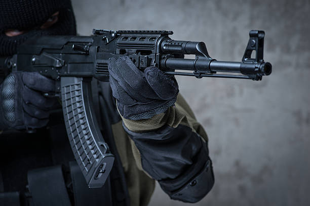 istock Soldier in balaclava with automatic rifle in hands 621580210