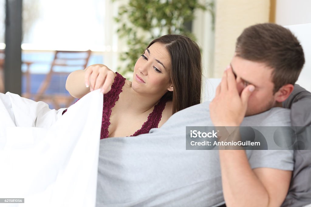 Man with erectile dysfunction during sex Man with erectile dysfunction during sex with her partner looking disappointed Penis Stock Photo