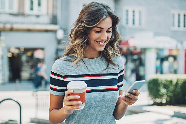 istock Beautiful girl texting outdoors 621581576