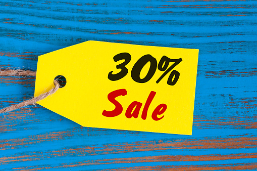 sale minus 30 percent. Big sales thirty percents on blue wooden background for flyer, poster, shopping, sign, discount, marketing, selling, banner, web
