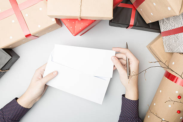 istock Hand is putting in envelope greeting card 621582690