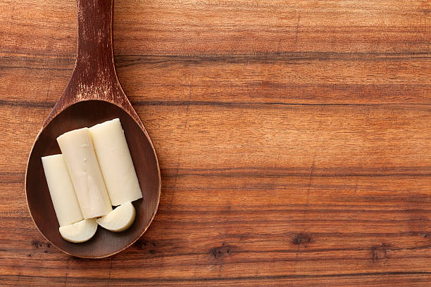 Hearts of palm Top view of wooden spoon over table with hearts of palm on it palm heart photos stock pictures, royalty-free photos & images