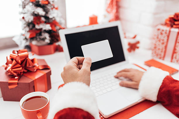 istock Santa holding a business card 621583942
