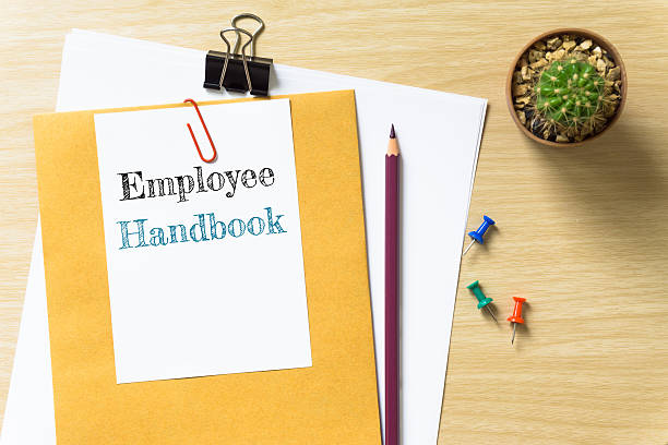 istock Employee Handbook, message on the white paper. 621583958