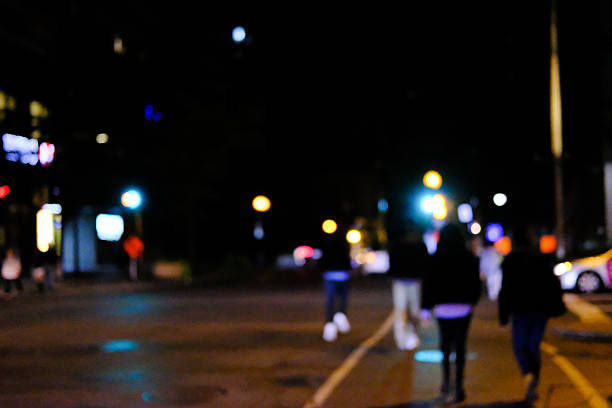 istock People Walking In A City Centre At Nightfall 621584156