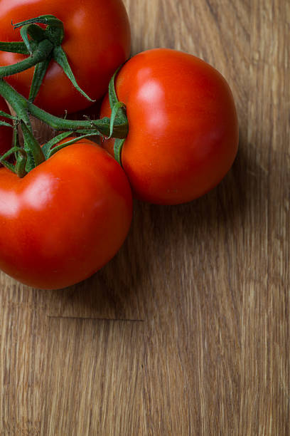 istock Fresh and tasty tomatoes on a wooden table 621584730