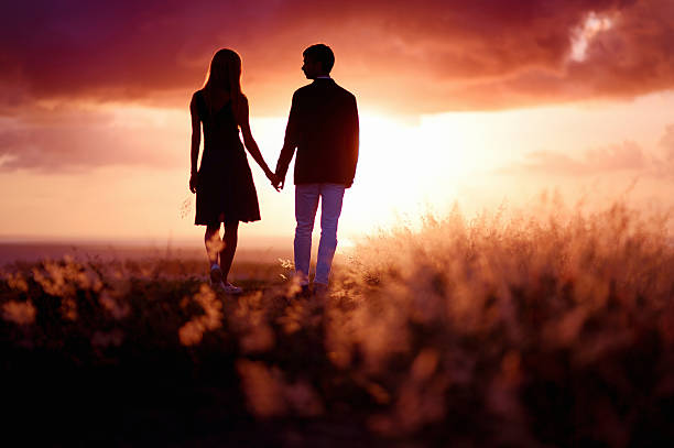 istock Young couple enjoying the sunset 621584830