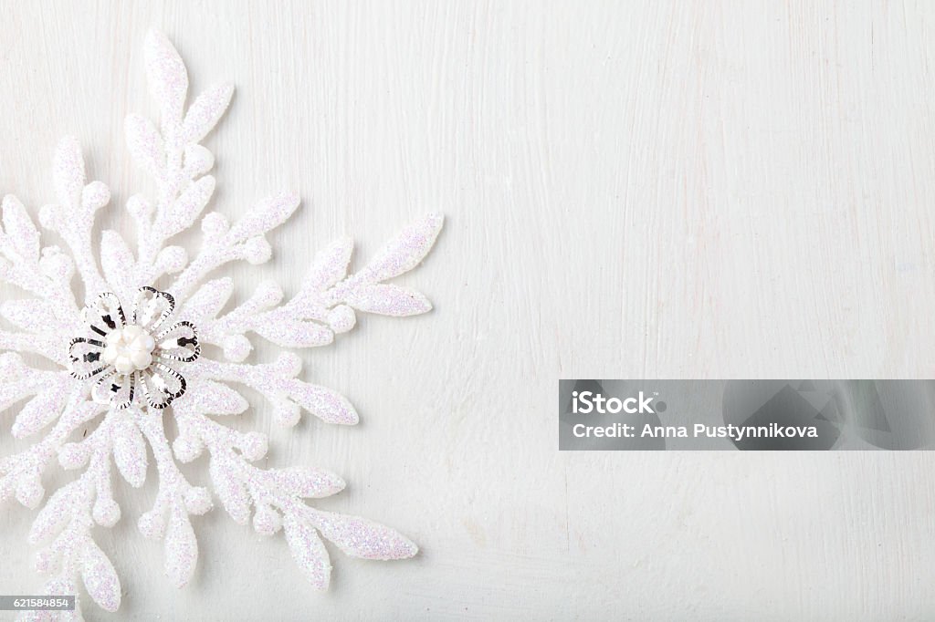 Christmas and New Year background Snowflake Christmas and New Year background. Snowflake on a white wooden background. Copy space. Arts Culture and Entertainment Stock Photo