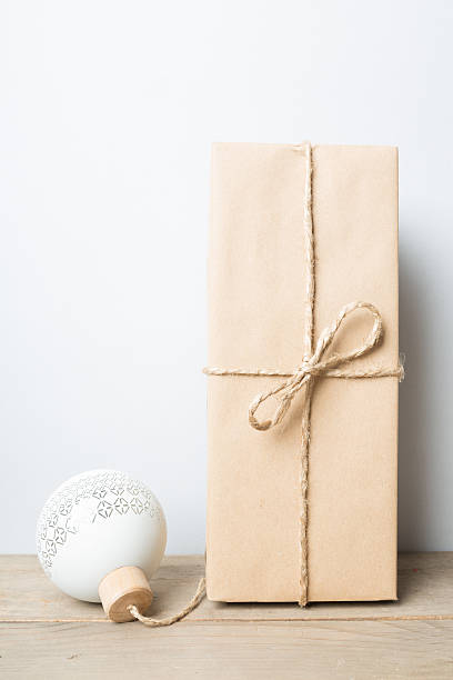istock Christmas ball with brown package wrapped with rope 621585468