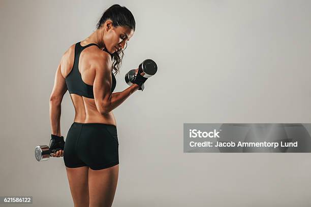 Fit Strong Young Woman Lifting Weights Stock Photo - Download Image Now - Women, Exercising, Gym