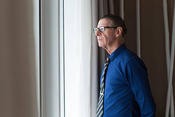 istock Thoughtful Senior Businessman Looking Out Window 621586264