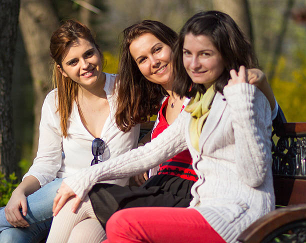 istock Female friends sitting on a bench 621586610