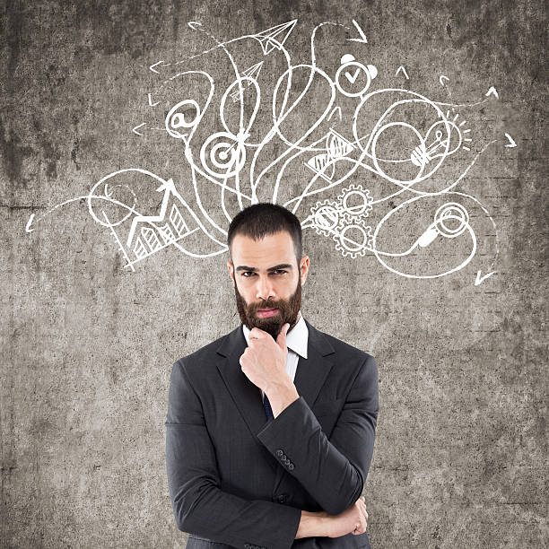 istock Businessman standing in front of wall 621587494