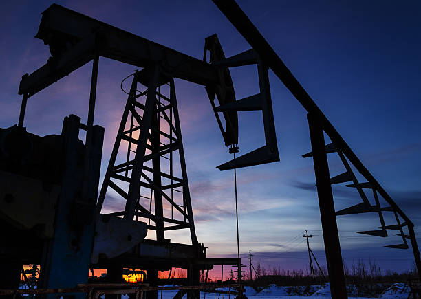 istock Oil pump and pipeline silhouette 621588566