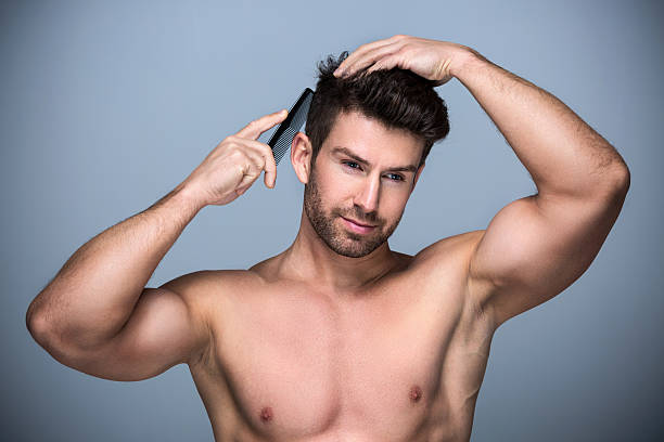 istock Man combing his hair 621589188