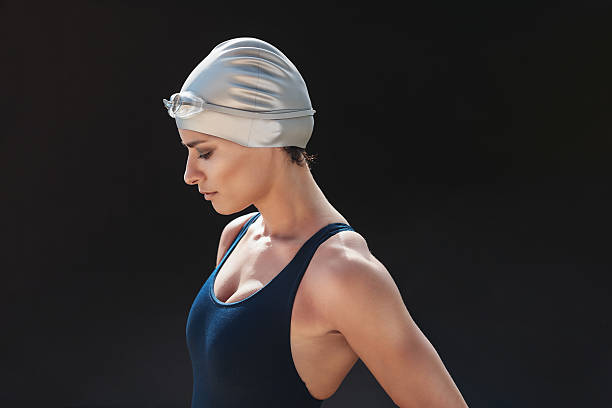 istock Professional swimmer standing on black background 621589528