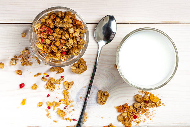 istock Granola, milk and honey in a glass. 621589708