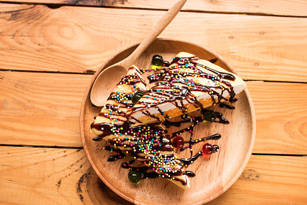 istock dessert with chocolate sauce on wooden plate 621590034