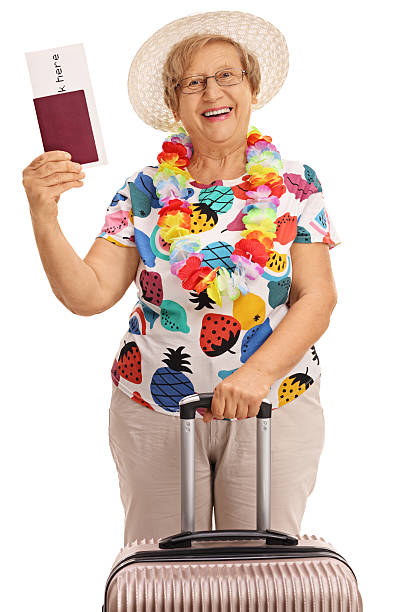 istock Elderly tourist holding a passport and a suitcase 621590136