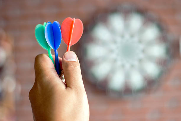 istock close up hand hold three color arrow in dart game 621590186