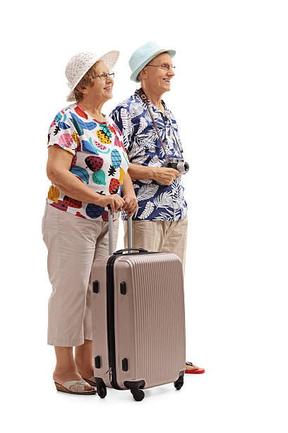 istock Senior tourists with a suitcase waiting in line 621590534