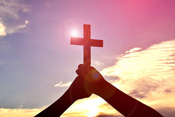 istock Silhouette people jesus and cross 621590946