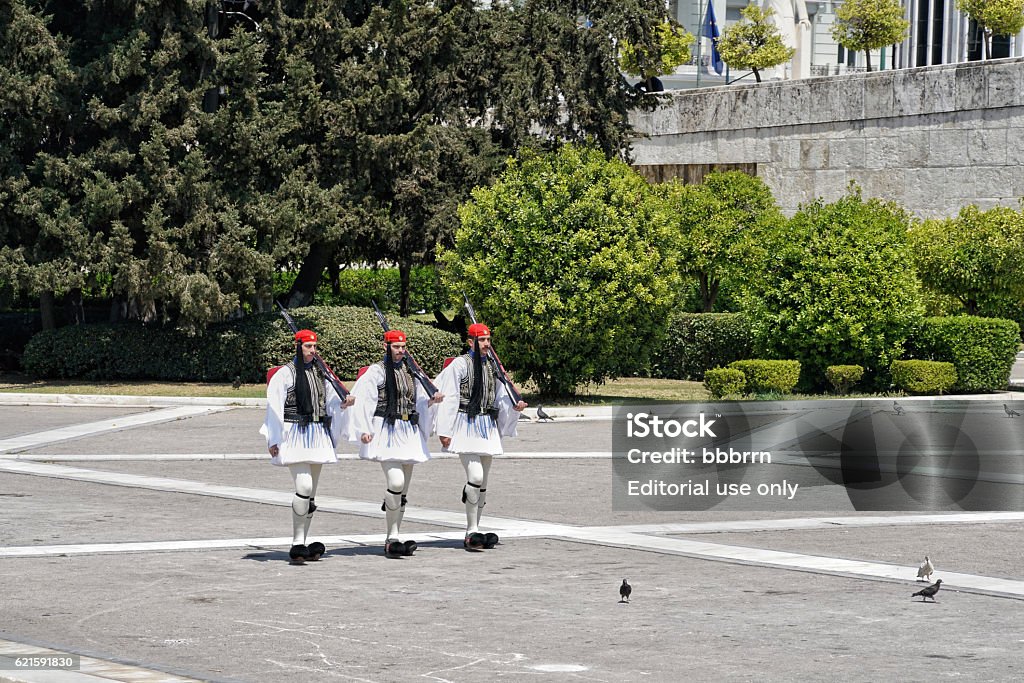 Evzon guards in Athens, Greece. Athens, Greece - April 30, 2016: Every sunday the ceremonial changing of Evzon guard can be watched in front of the Tomb of the Unkown Soldier in Athens, Greece Adult Stock Photo