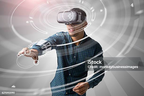 Man Using Virtual Reality Headset Stock Photo - Download Image Now - Virtual Reality Simulator, Virtual Reality, Technology