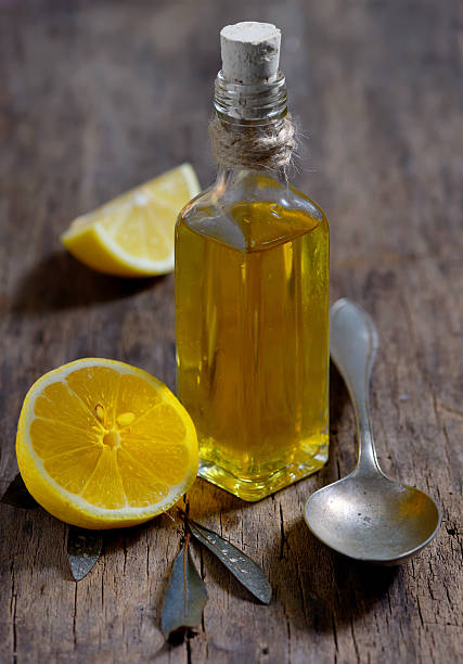 Olive oil and  lemon fruits on the wooden table stock photo