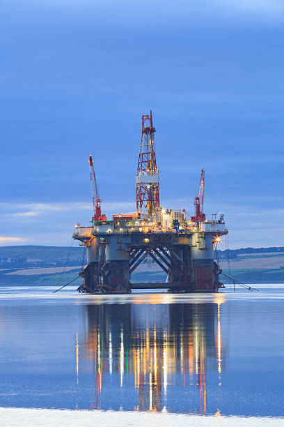 Semi Submersible Oil Rig during Sunrise Semi Submersible Oil Rig during Sunrise at Cromarty Firth in Invergordon, Scotland ballast water stock pictures, royalty-free photos & images
