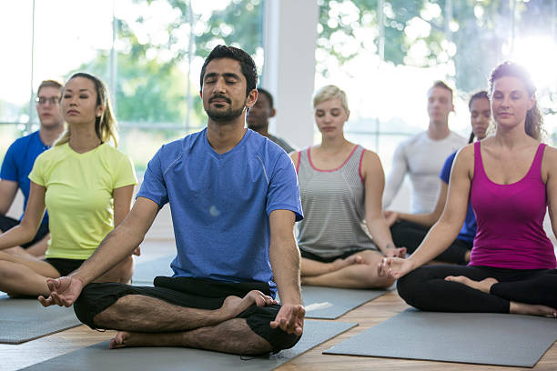 istock Group Meditation in a Yoga Class 621593930
