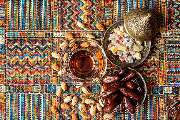 istock sweets, dates and tea on a traditional Arabian carpet 621594760