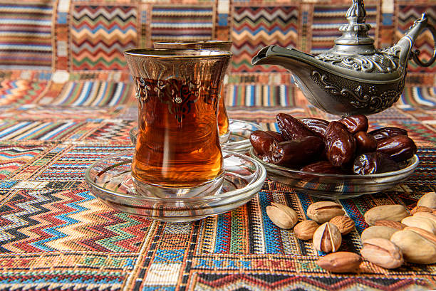 istock dates and tea on a traditional Arabian carpet 621595110