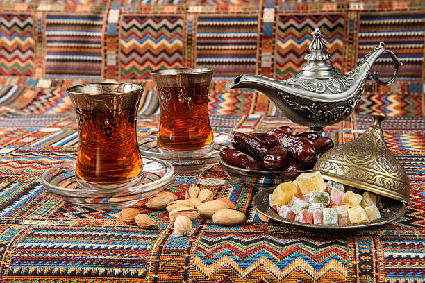 istock sweets, dates and tea on a traditional Arabian carpet 621595434