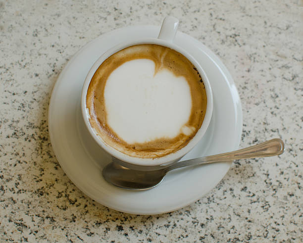 istock Cup of cappuccino on the table. View from above. 621598594