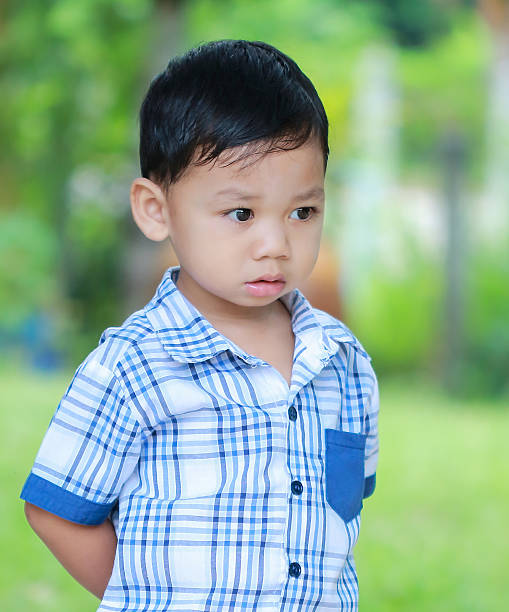 istock The boy standing eyes staring ahead. 621599574