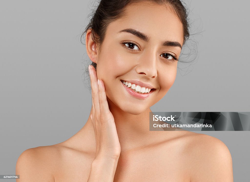 Beautiful Face of young woman with perfect skin. Gray background Beautiful Face of Young Woman Model with Clean Fresh Perfect Healthy Skin. Age and Health Concept. Beauty Woman Portrait isolated on gray background Transparent Stock Photo
