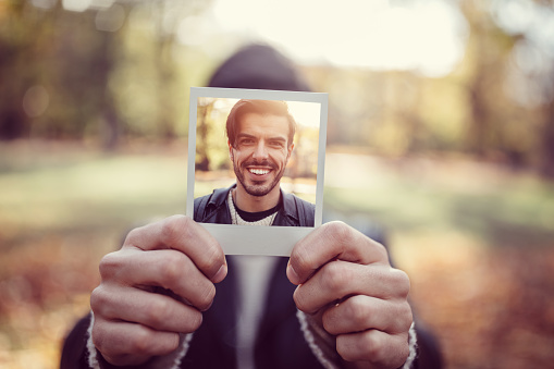Smiling man showing self photo